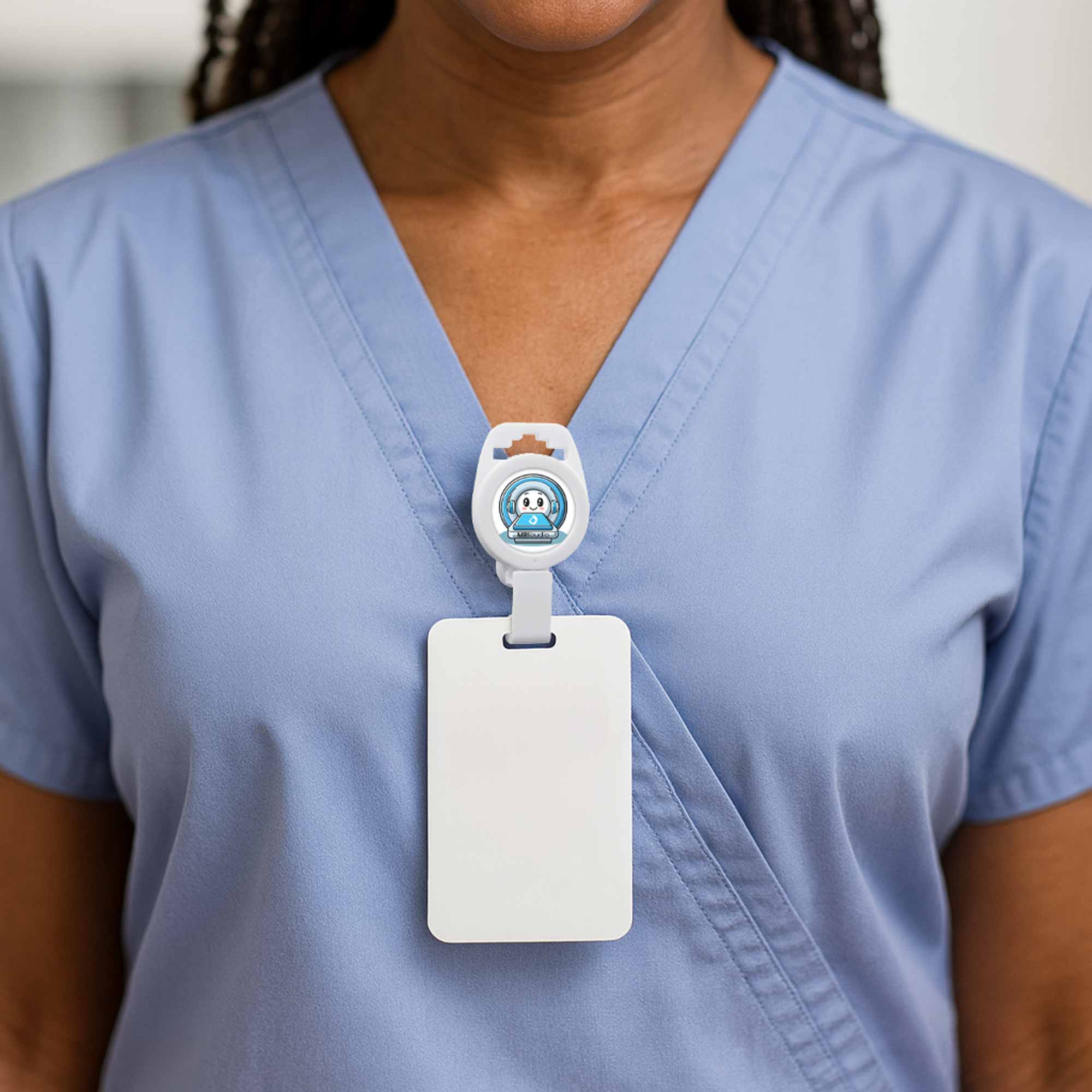 Person wearing a blue scrub top with a MRI safe non-magnetic white badge holder, clipped to shirt. 